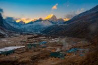 Amazing Sunset of Pheriche by Babin Dulal captures a vibrant sunset over a tranquil village and majestic mountains.